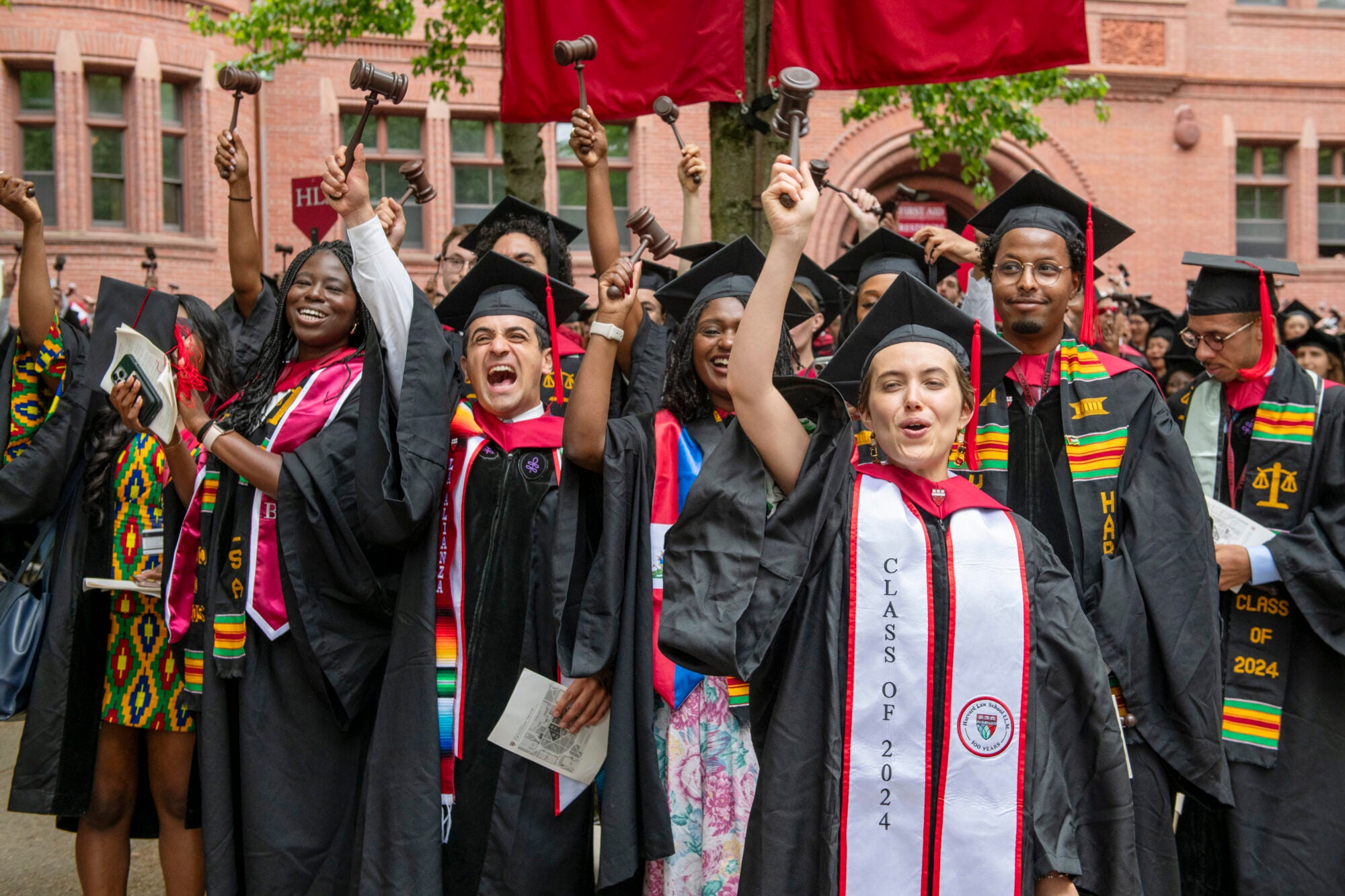 Harvard Law School students in cap and gown with gavels